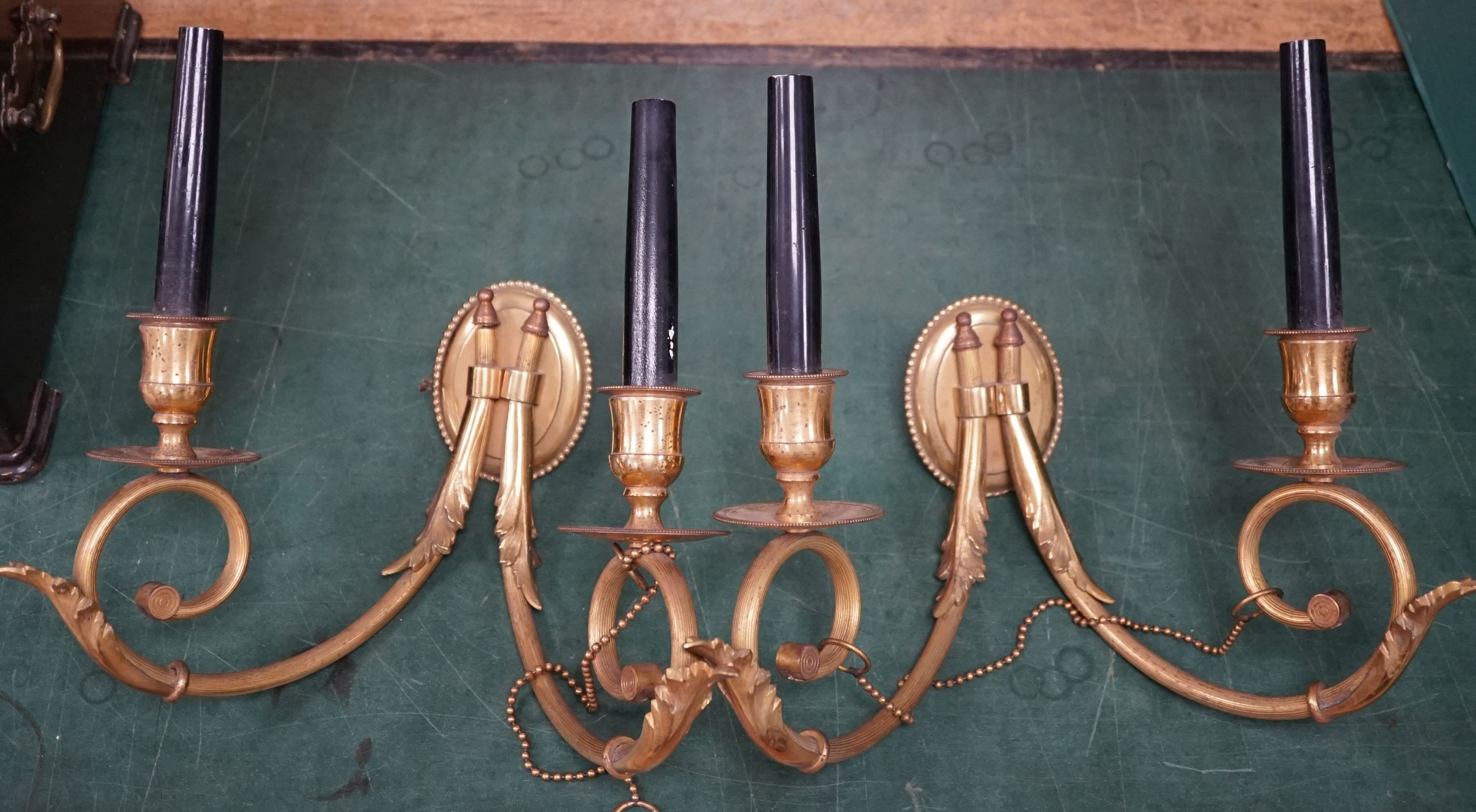 A pair of Adam design brass two branch wall lights